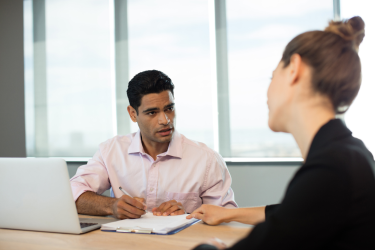 two colleagues , one is  rehearsing for a job interview